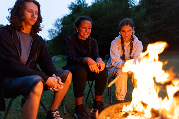istock Teenagers around a campfire at dusk 2233068157