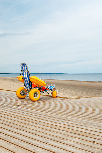 istock Beach Wheelchair on Boardwalk Facing Open Water and Sandy Shoreline 2233068159