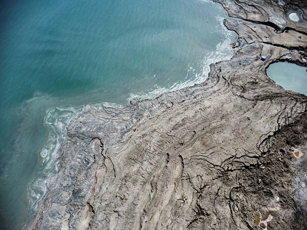 Aerial drone shot of the rocky coastline and the water near the sinkholes