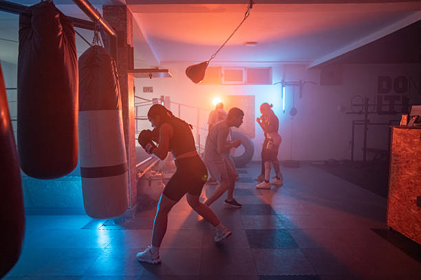 istock Diverse Group Training Boxing in a Gym With Atmospheric Lighting 2233070753