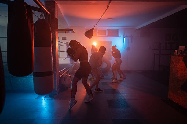 istock Group Training in a Boxing Gym with Atmospheric Lighting and Focused Efforts 2233070756