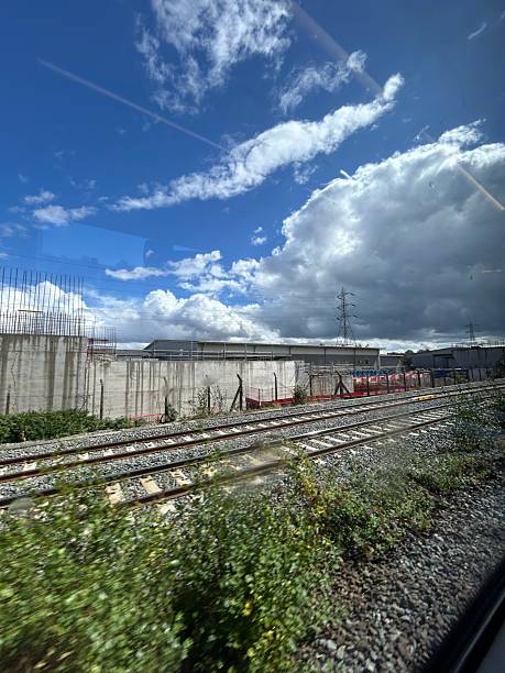 istock Railway Tracks Near Construction Site Under a Dramatic Sky with Clouds 2233070757