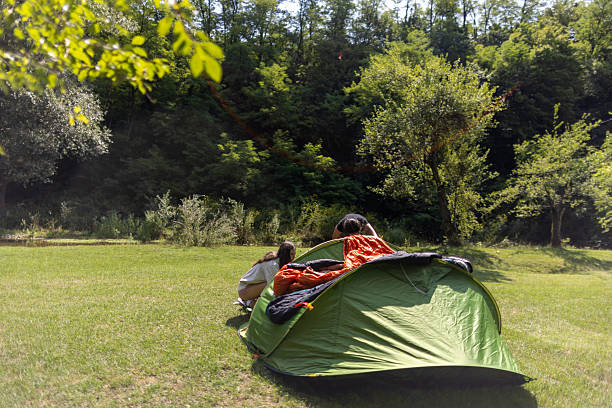 istock Putting up a tent on a camping trip 2233071013