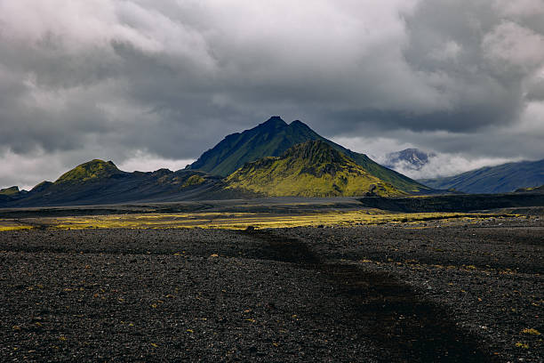 istock green mountains and black sand 2233073013
