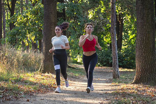 istock Beautiful friends running in the forest 2233074830