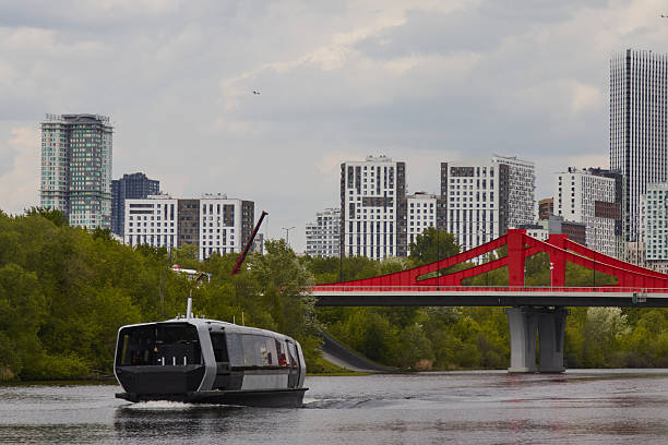 Moscow, Russia, September 28, 2023: Tour boat on the Moskva River and old architecture on the riverbank on a clear day
