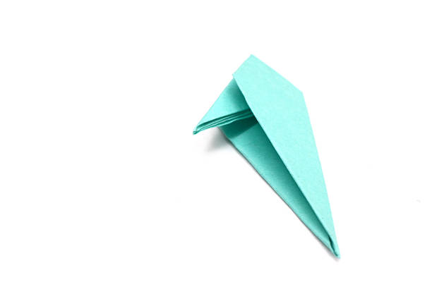 A blue origami flower plant on white