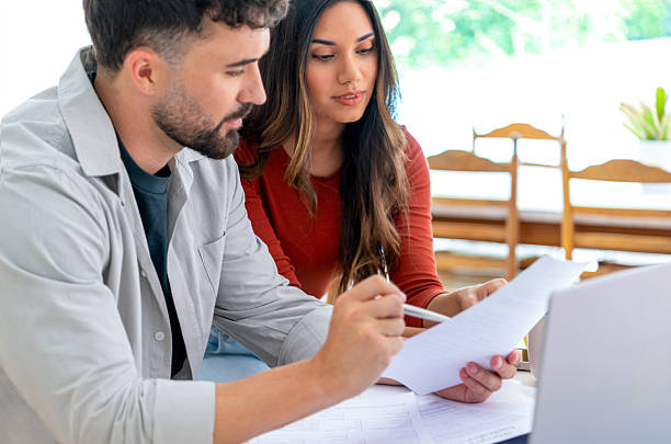 istock Young couple doing paperwork  and finances at home in the kitchen. 2233078795