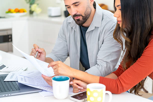 istock Young couple doing paperwork  and finances at home in the kitchen. 2233078811