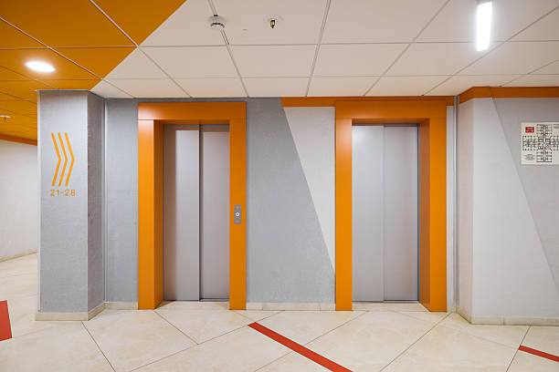 istock The modern elevator lobby features vibrant orange accents, making it bright and inviting 2233081113