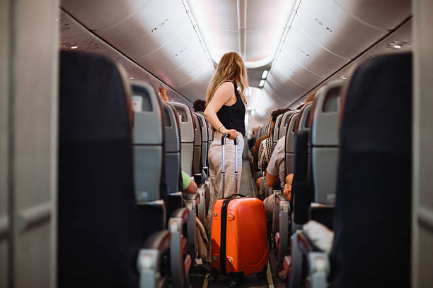 istock Interior of airplane with people sitting on seats 2233081372