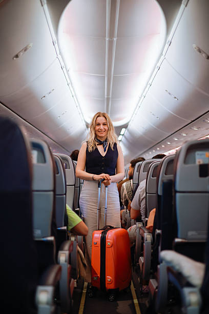 istock Interior of airplane with people sitting on seats 2233081819