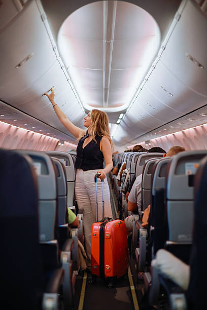 istock Interior of airplane with people sitting on seats 2233081984