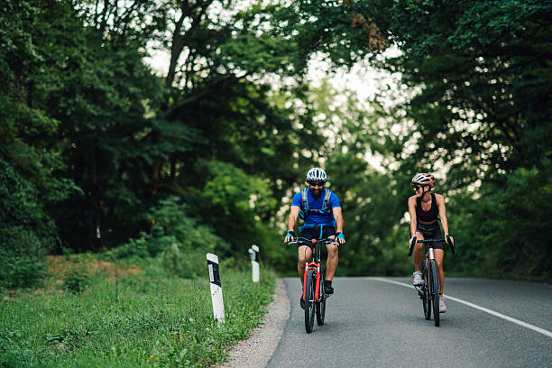 istock Couple cycling on scenic forest road, enjoying summer exercise 2233083205
