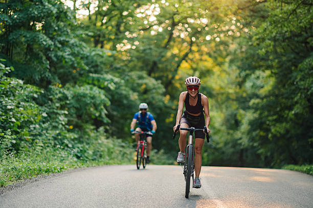 istock Cyclists riding bicycles on scenic forest road 2233083225