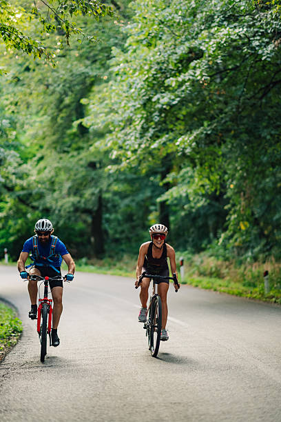 istock Cyclists riding bicycles on scenic forest road 2233083229