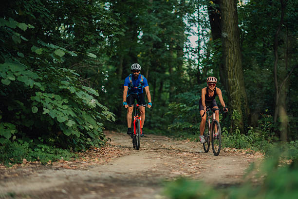 istock Cyclists riding mountain bikes on forest trail 2233083248