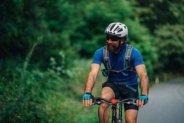 istock Mountain biker enjoying a ride on a forest road 2233083285