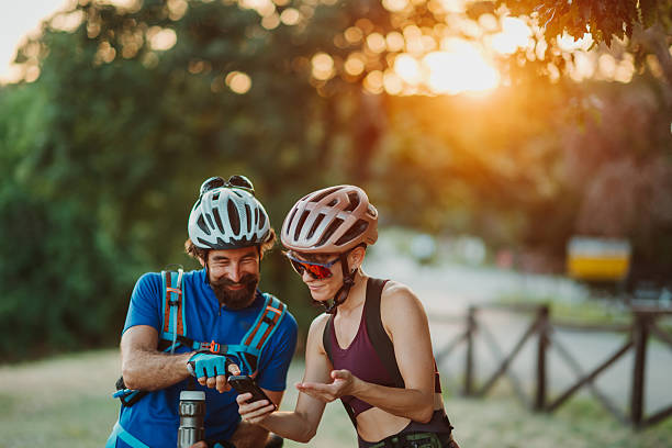 istock Cyclists consulting smartphone during sunset break 2233083331