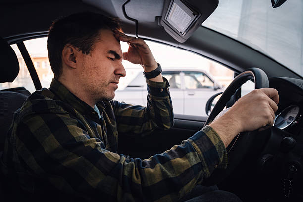 istock Car accident concept. Upset man driver sitting at front seat and touching his head, having automobile crash. guy getting late for flight, got stuck in traffic, side view 2233087263