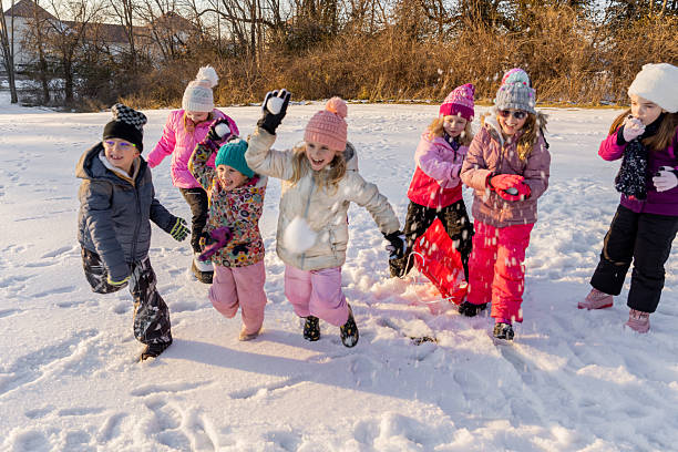 istock Group of Kids Enjoy Playing in the Snow 2233087334