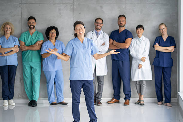istock Cheerful healthcare team displaying open arms in unity. 2233087378