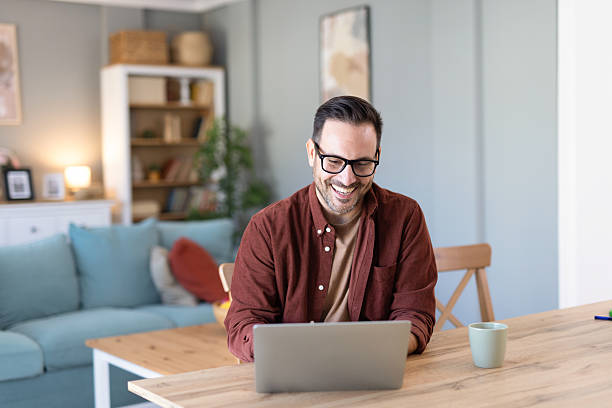 istock Thoughtful Man Casually Engrossed in Laptop in Living Space 2233087425