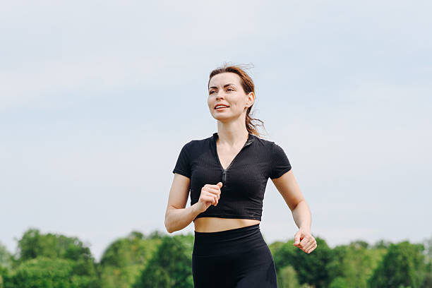 istock young woman runs in city park 2233087625