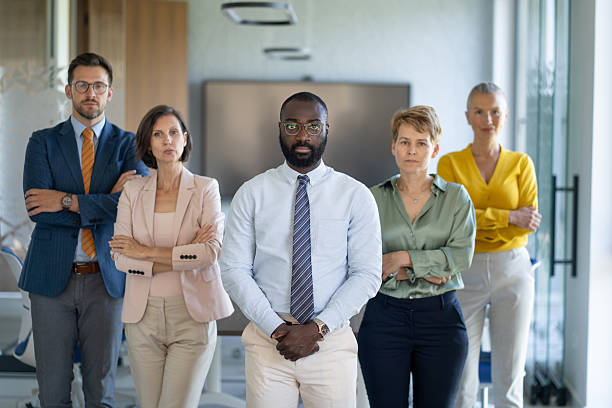 istock Serious business team standing with arms crossed in office 2233088061