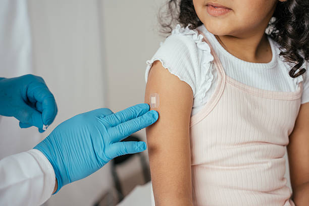 istock Doctor putting a protector on child's arm after vaccination - disease prevention 2233089214