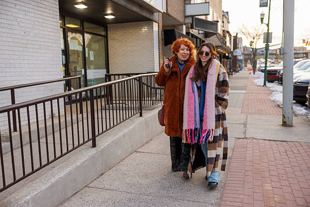 istock Mother and daughter walking together. Winter stroll on downtown sidewalk 2233089721
