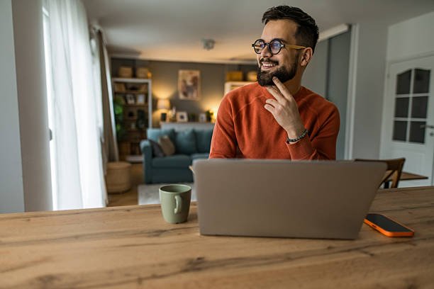 istock Young man working from home on laptop. 2233091591