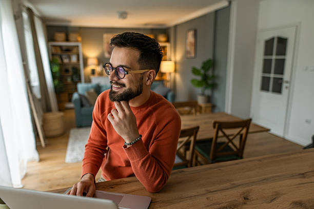 istock Young man working from home on laptop. 2233091648