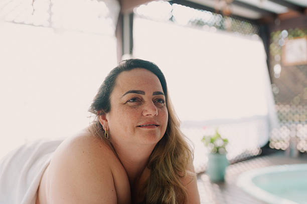 Plus-size woman wrapped in towel at spa