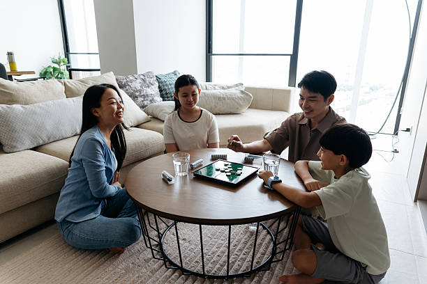 istock Happy Family Playing Board Game at Home 2233093493
