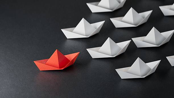 istock Leadership concept. Red leader paper ship leading among white on black background. copy space.3D rendering on black background. 2233095961