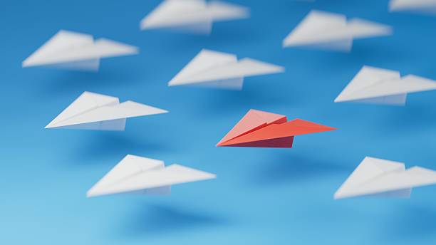 istock Different business concept.new ideas. paper art style. creative idea. red leader plane, standing out from the crowd of white planes.3D rendering on blue background. 2233095962