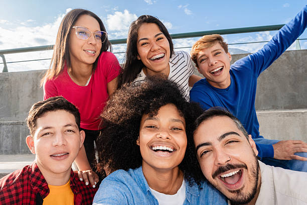 istock Multiracial friends taking selfie celebrating outdoors in summer 2233097116