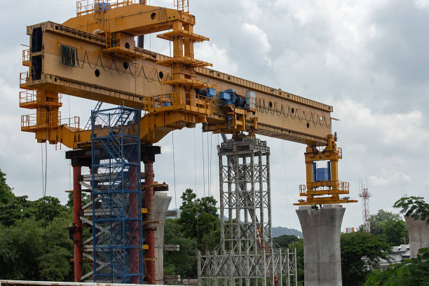 istock construction industry building infrastructure. motorway bridge architecture with crane and concrete pillars 2233097759