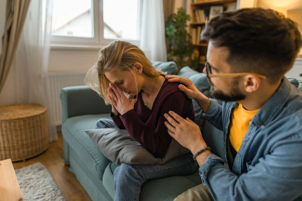 istock Distraught girlfriend being consoled by her boyfriend at home. 2233099613