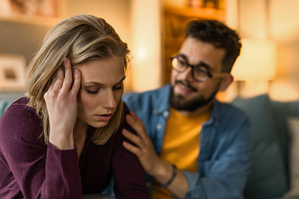 istock Distraught girlfriend being consoled by her boyfriend at home. 2233099808