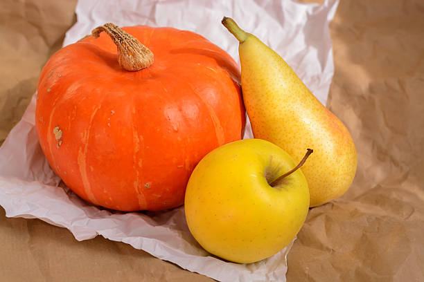 Apple, pear and orange pumpkin in horizontal format