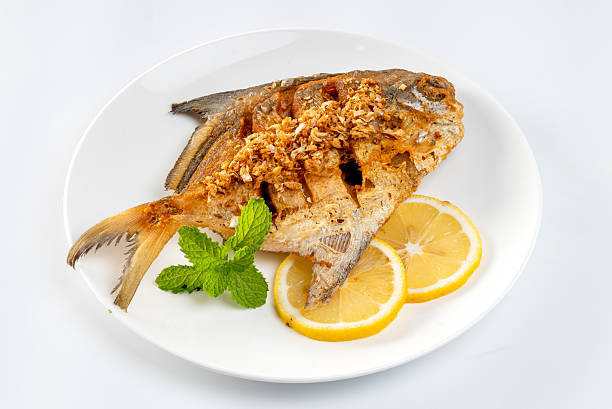 istock Fried sea bass with garlic on a white plate 2233101001