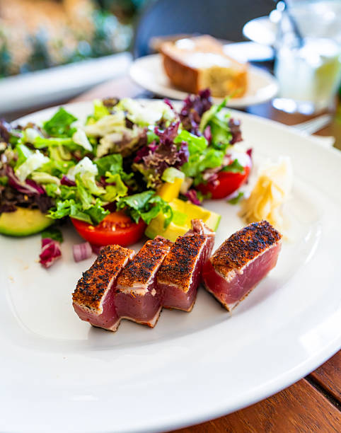 Seared tuna slices served with fresh salad and vegetables
