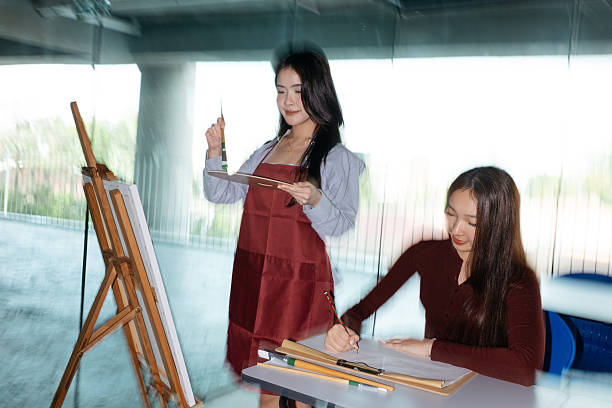 istock Young female university students having art class together 2233106023
