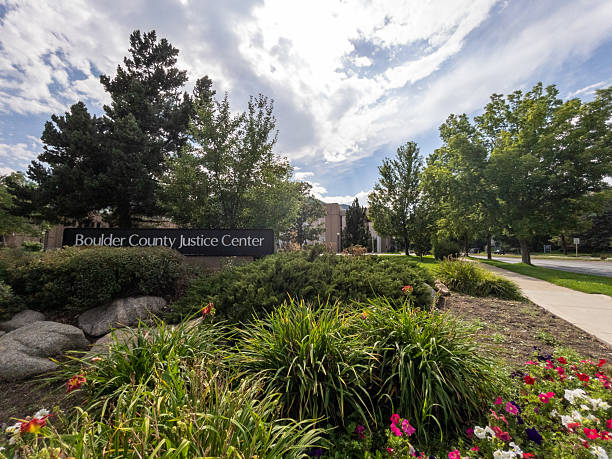 istock Boulder county justice center sign with lush landscaping and cloudy sky 2233106032