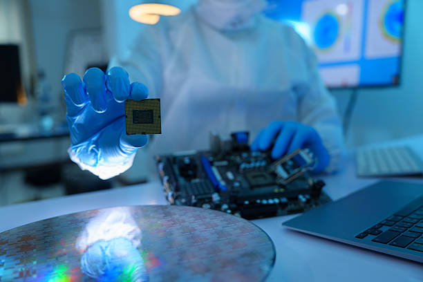 istock Analysts are manufacturing semiconductors at an electronics manufacturing plant. Workers or engineers wear medical protective suits or white gowns covered with silicon wafers. 2233107078