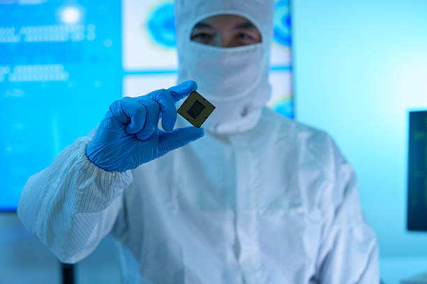 istock Analysts are manufacturing semiconductors at an electronics manufacturing plant. Workers or engineers wear medical protective suits or white gowns covered with silicon wafers. 2233107113