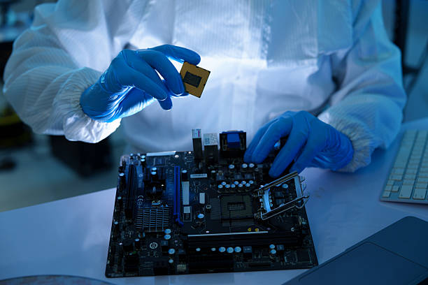 Analysts are manufacturing semiconductors at an electronics manufacturing plant. Workers or engineers wear medical protective suits or white gowns covered with silicon wafers.
