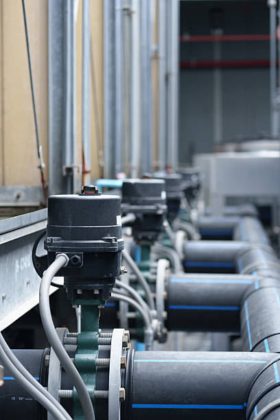 Air conditioning (HVAC) on the roof of an industrial building with blue sky.